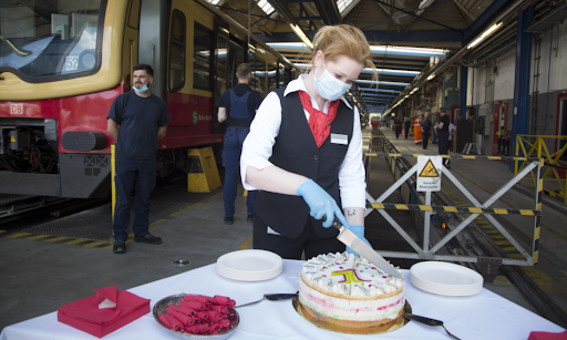 Deutsche Bahn employees celebrating the success of the Starke Schiene campaign and employees dedication next to the tracks with plenty of cake for everyone.