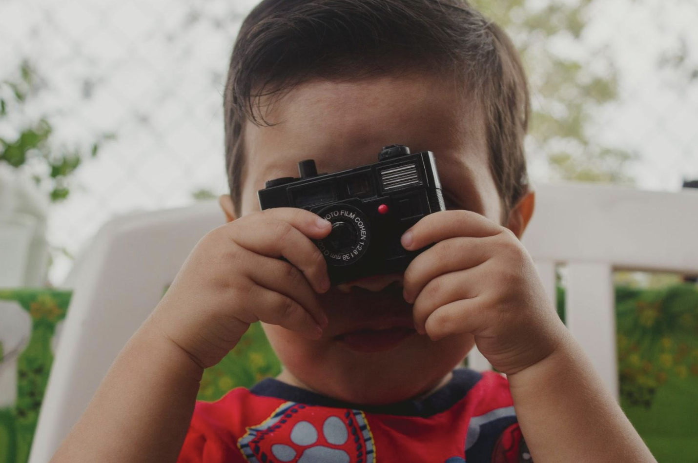 Little kid holding a camera