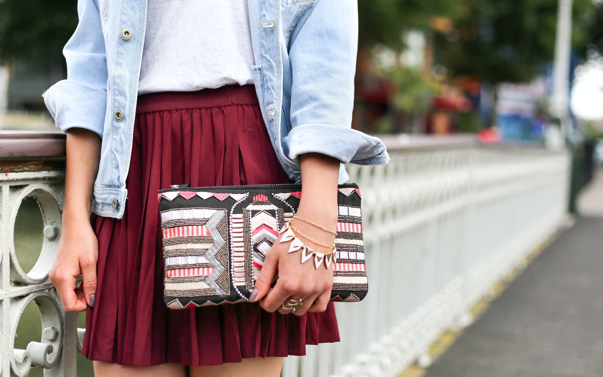 Woman not showing her face wearing a skirt and purse