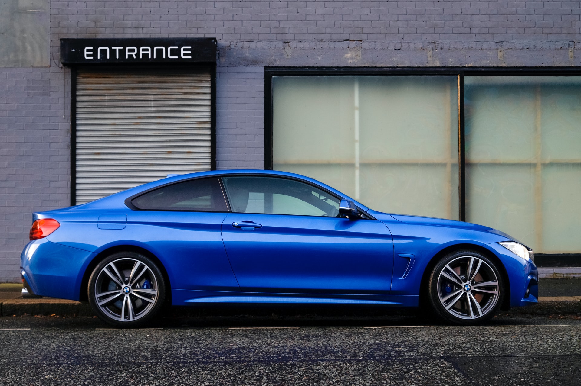 Shiny blue car parked on a street