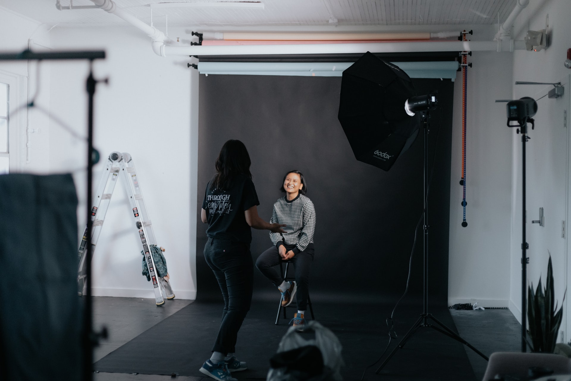 Woman sitting on a chair in a photo studio