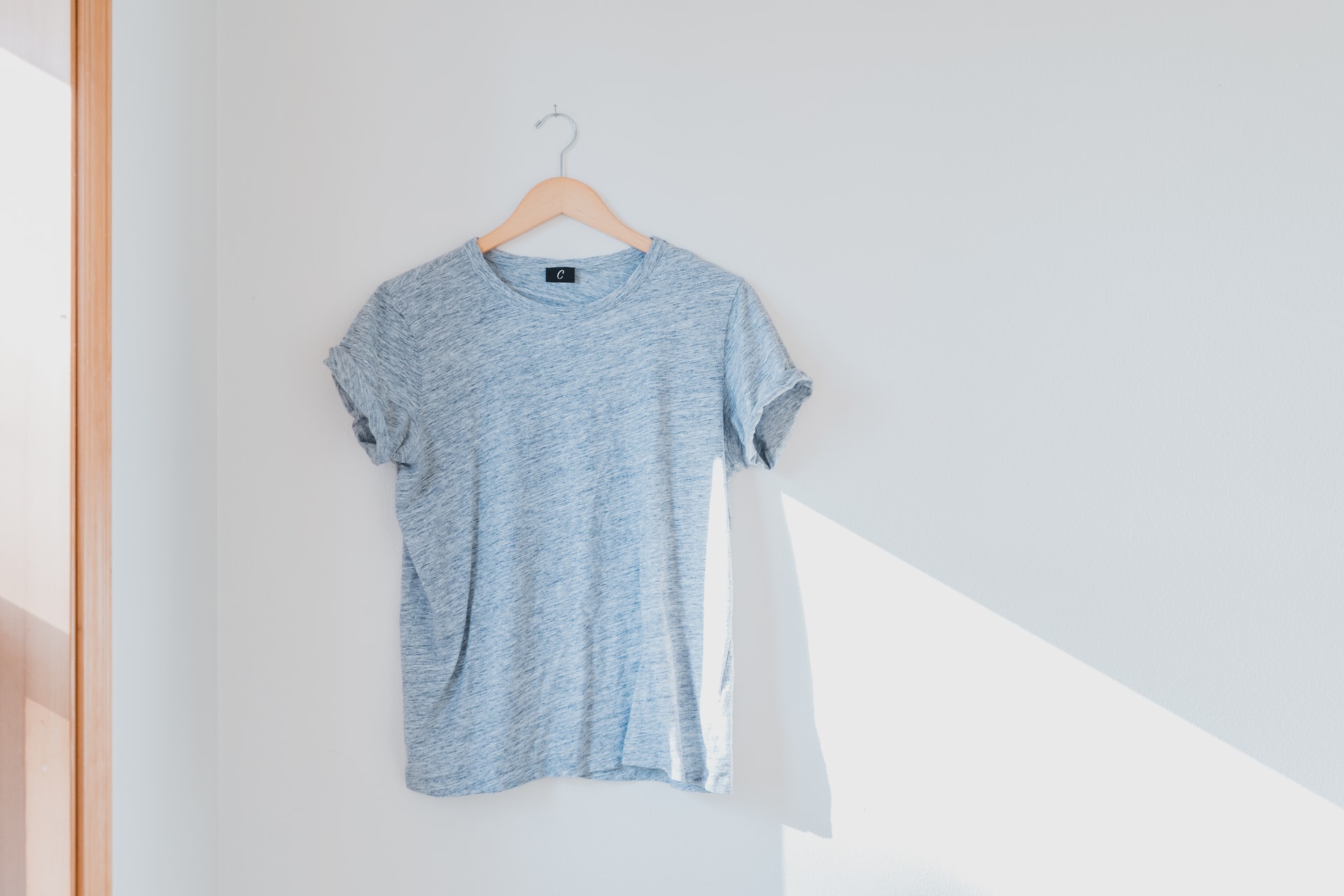 Another example of how to take good pictures of clothes to sell: t-shirt hanging on a white wall