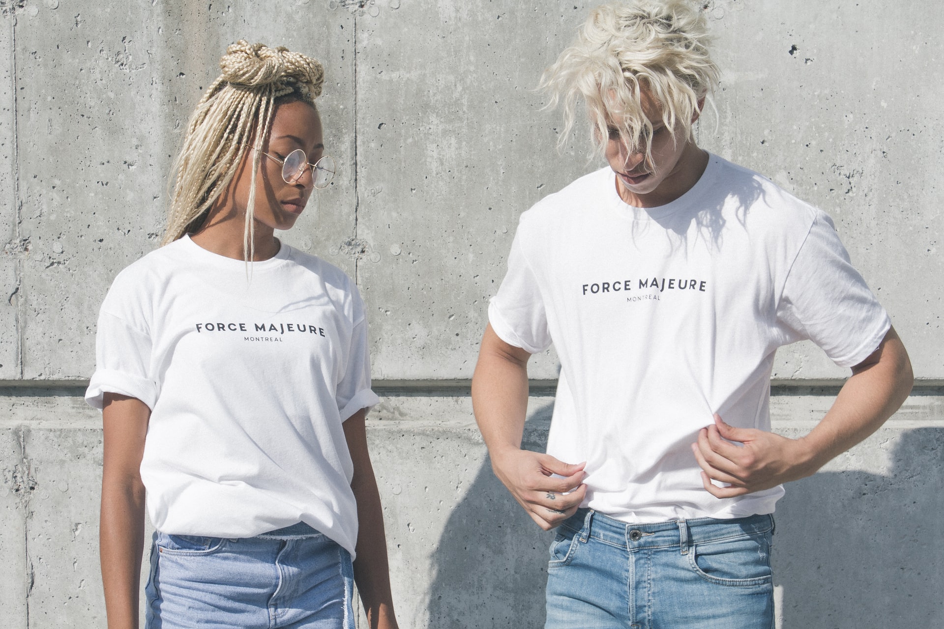 Woman and man showcasing their t shirts