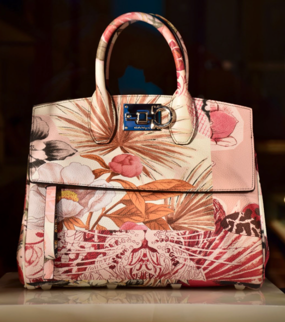 Bag with flower motives on a shiny surface